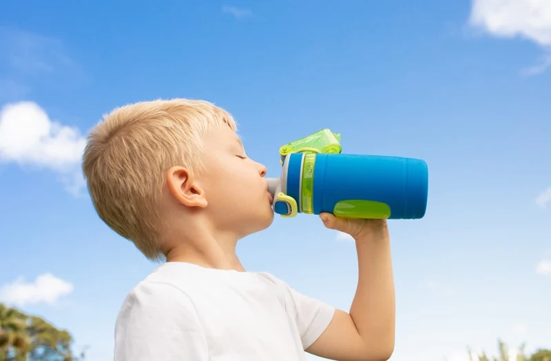 Blonde Boy Drinking Bottle
